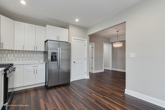 kitchen with black range with gas stovetop, white cabinetry, and stainless steel fridge