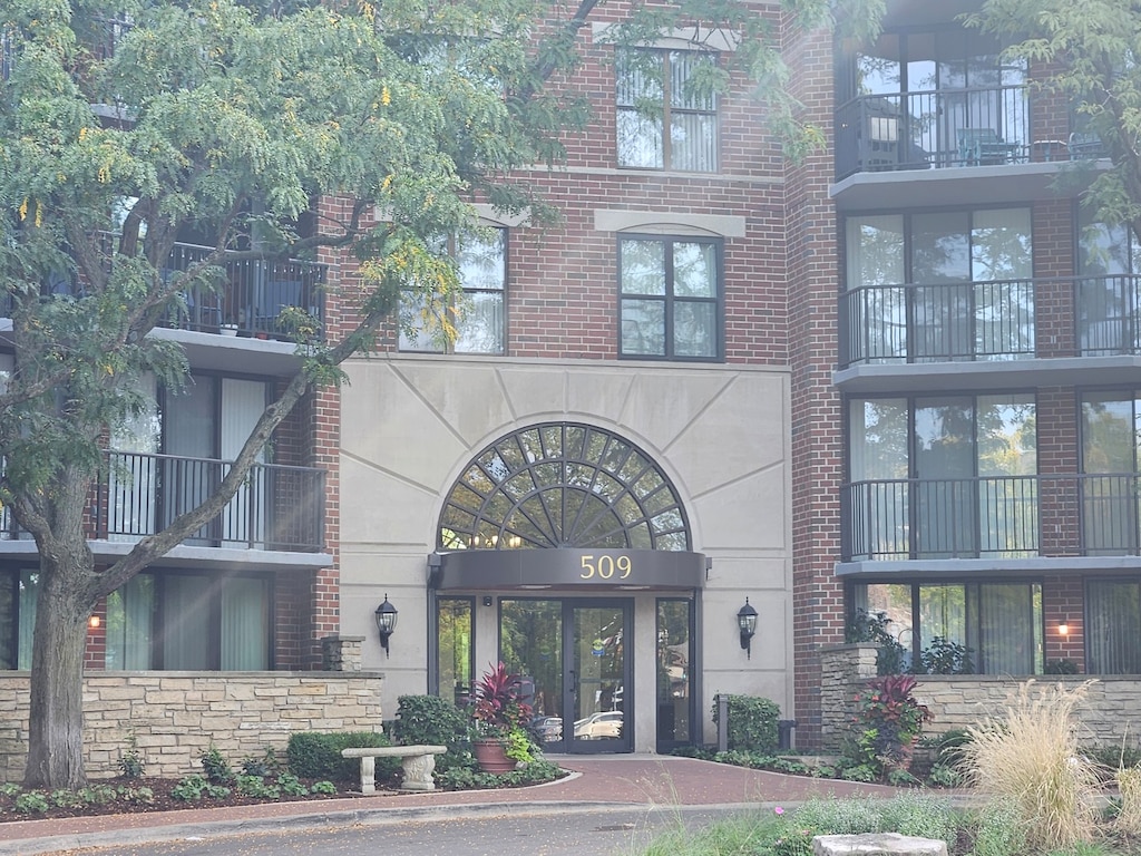 entrance to property with a balcony