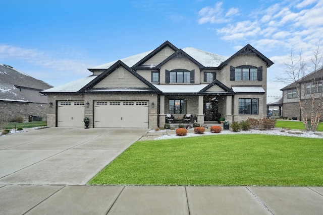 view of front of home with a front yard, a porch, and a garage