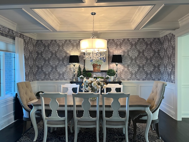 dining space featuring wood-type flooring, ornamental molding, and an inviting chandelier