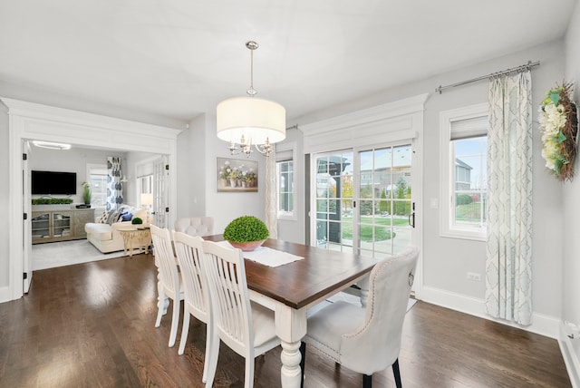 dining area featuring dark hardwood / wood-style floors and a notable chandelier