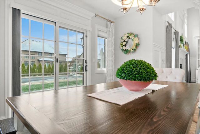 dining area featuring a healthy amount of sunlight and a chandelier