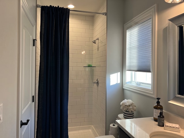 bathroom with curtained shower, vanity, and toilet