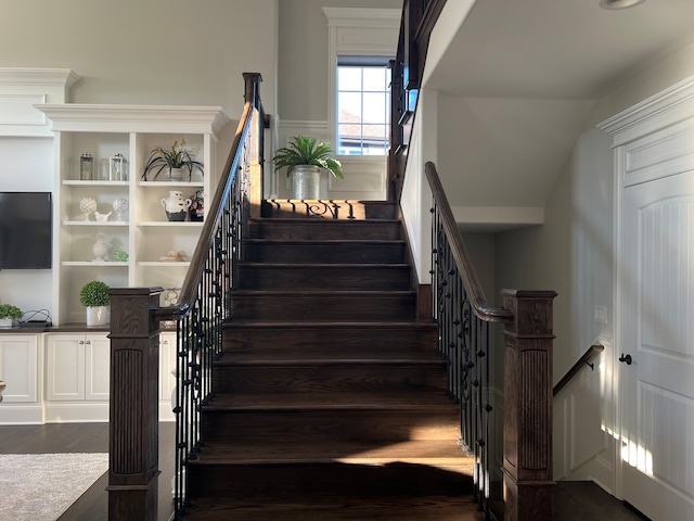 stairs with vaulted ceiling and hardwood / wood-style flooring