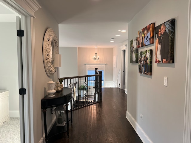 hall featuring dark hardwood / wood-style flooring and a chandelier