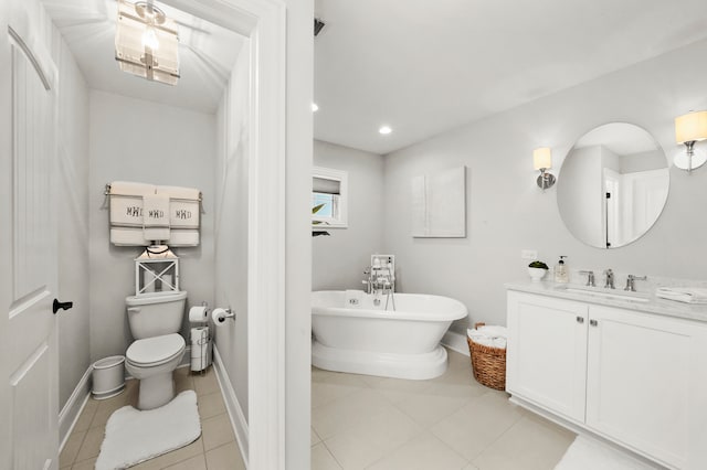 bathroom featuring tile patterned flooring, vanity, toilet, and a tub