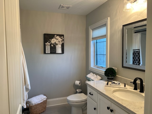 bathroom featuring vanity and toilet