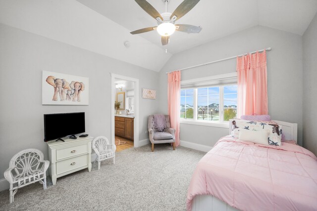 bedroom with carpet flooring, ceiling fan, ensuite bathroom, and lofted ceiling