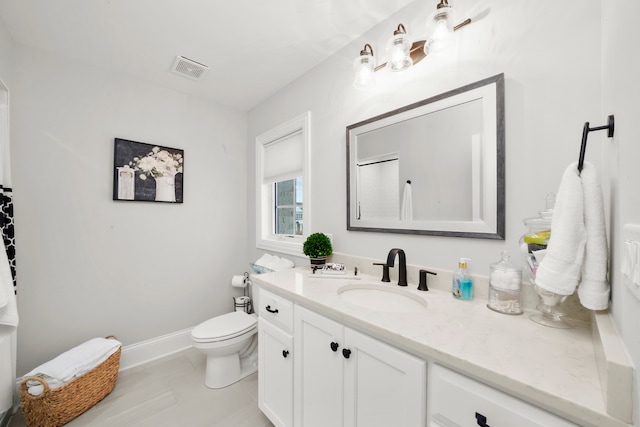 bathroom featuring vanity and toilet