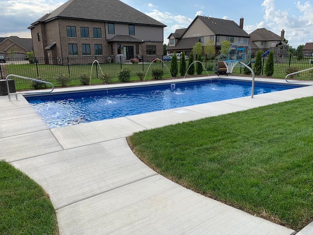 view of swimming pool featuring a lawn and pool water feature