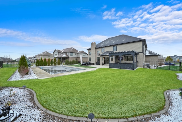 rear view of property with a pergola, a lawn, and a covered pool