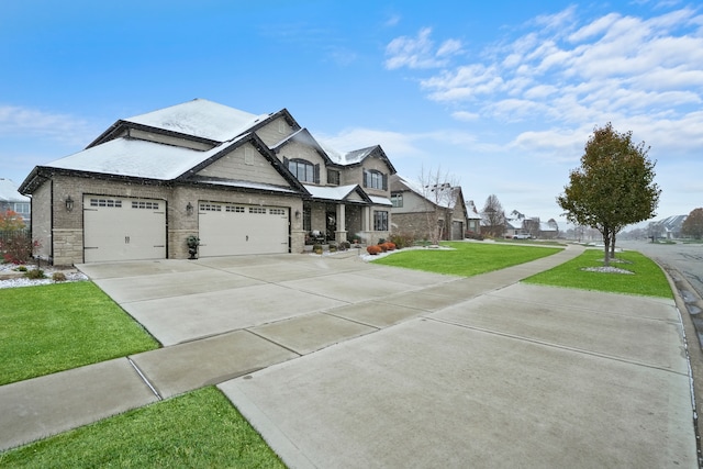 craftsman inspired home with a garage and a front lawn