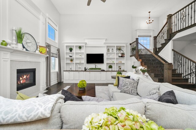 living room with dark hardwood / wood-style floors and ceiling fan