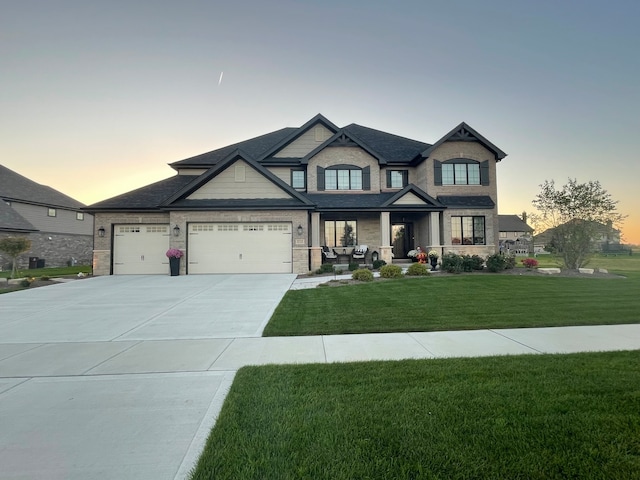 view of front of home featuring a garage and a yard