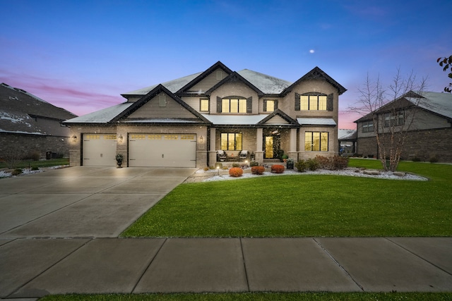 craftsman inspired home with a lawn and a garage