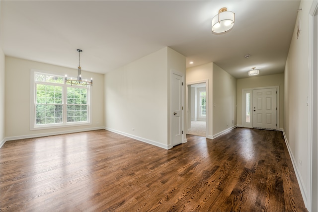 entrance foyer featuring dark wood-type flooring and a chandelier