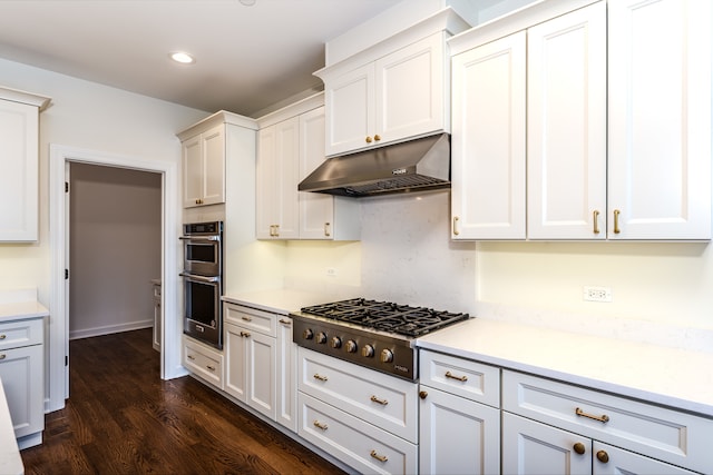 kitchen featuring white cabinetry, appliances with stainless steel finishes, and dark hardwood / wood-style flooring