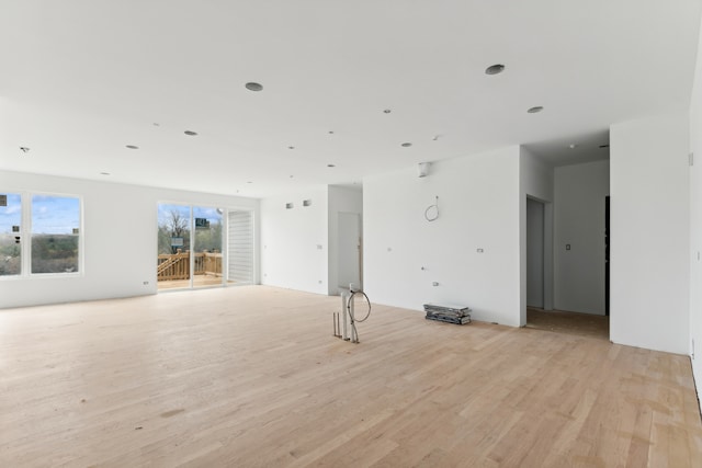 unfurnished room featuring light wood-type flooring and a wealth of natural light