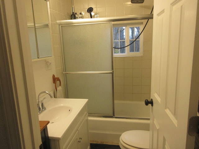 full bathroom with vanity, shower / bath combination with glass door, and toilet