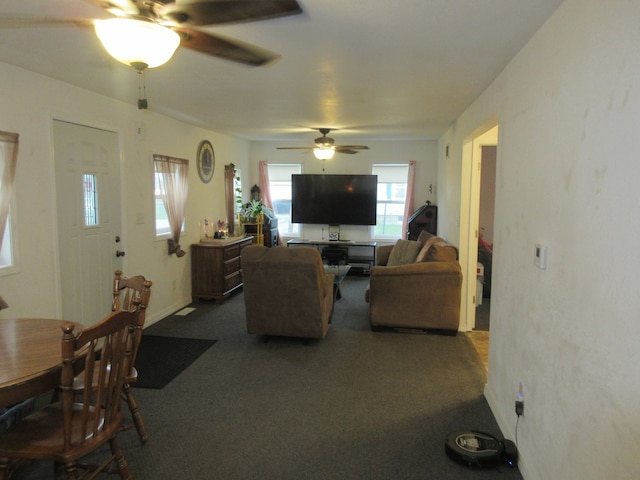 carpeted living room with ceiling fan