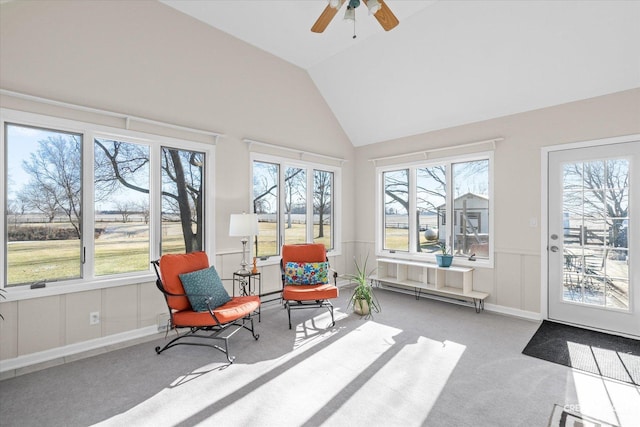 sunroom / solarium with ceiling fan and vaulted ceiling