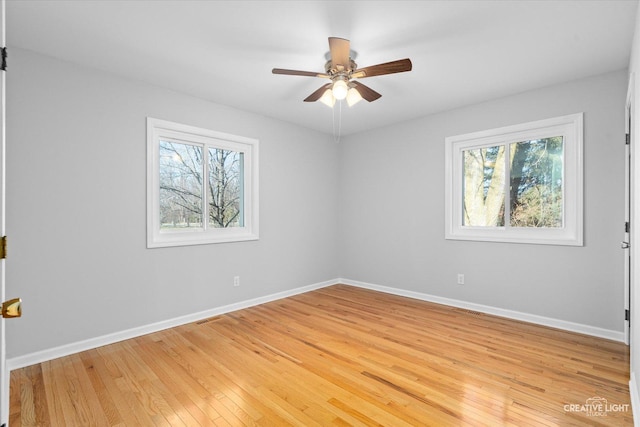 spare room with ceiling fan and light wood-type flooring