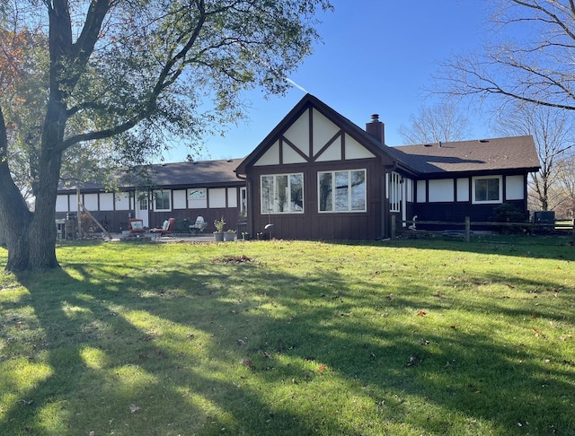 rear view of property with a yard