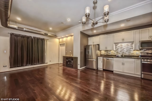 kitchen featuring stainless steel appliances, dark hardwood / wood-style floors, and white cabinets