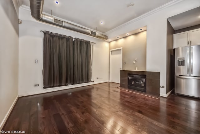 unfurnished living room featuring crown molding and dark hardwood / wood-style floors