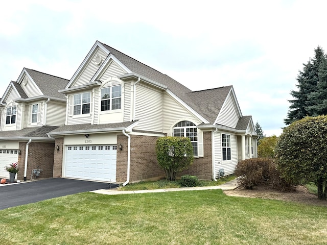 view of front of house with a front lawn and a garage