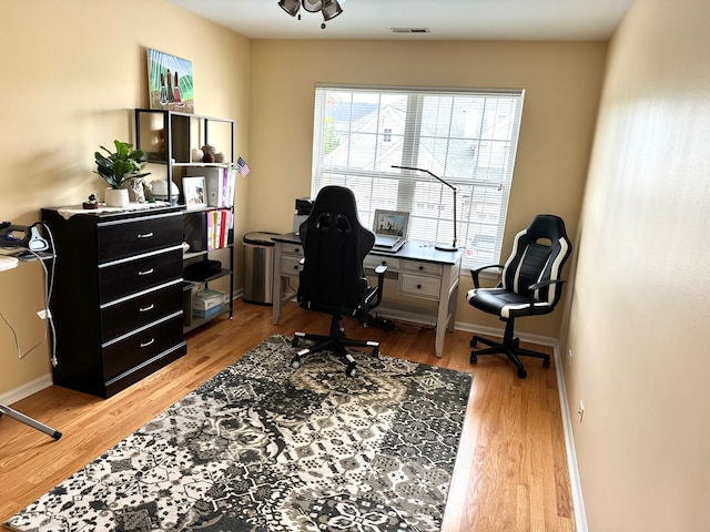 office space with wood-type flooring