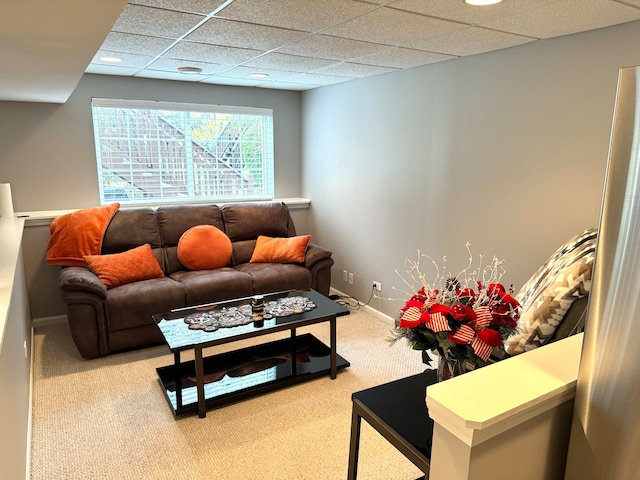 living room with carpet flooring and a drop ceiling