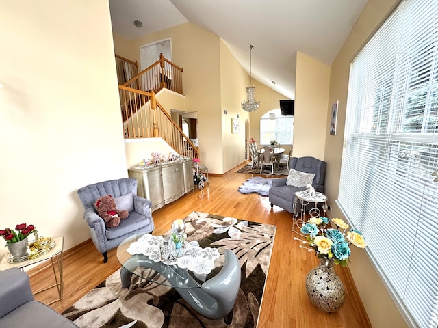 living room featuring high vaulted ceiling and hardwood / wood-style flooring