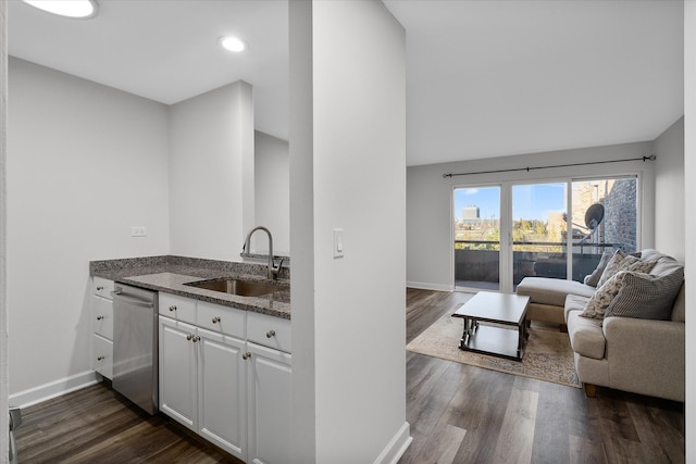 kitchen with stainless steel dishwasher, white cabinetry, sink, and dark wood-type flooring