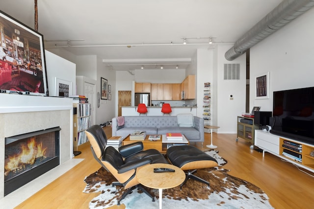 living room featuring track lighting and light hardwood / wood-style flooring