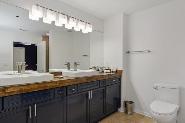 bathroom featuring vanity, toilet, and tile patterned flooring