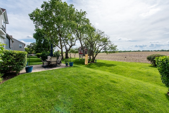 view of yard featuring a rural view and a patio