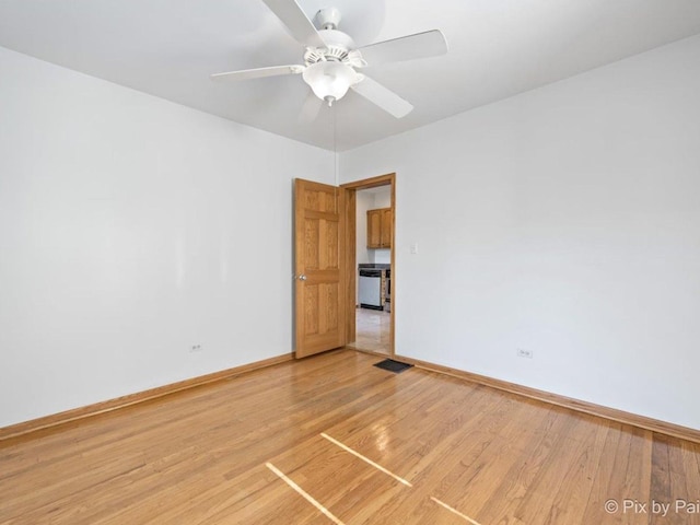 empty room with hardwood / wood-style floors and ceiling fan