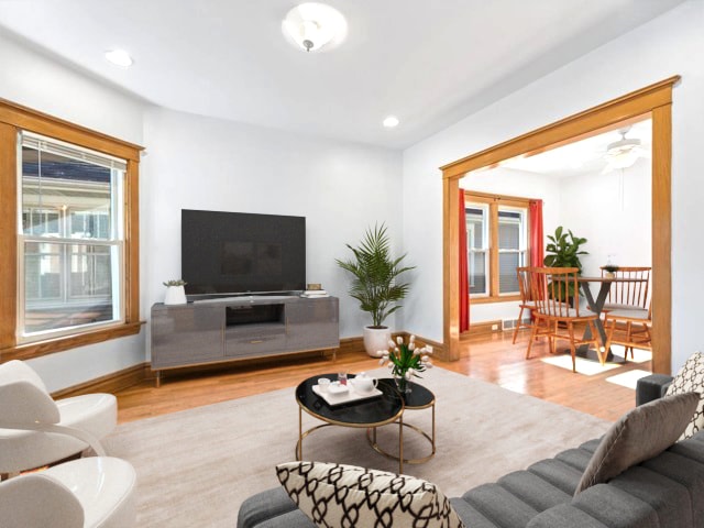 living room featuring ceiling fan and light wood-type flooring