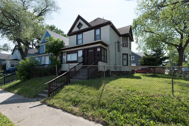 victorian home with a front lawn