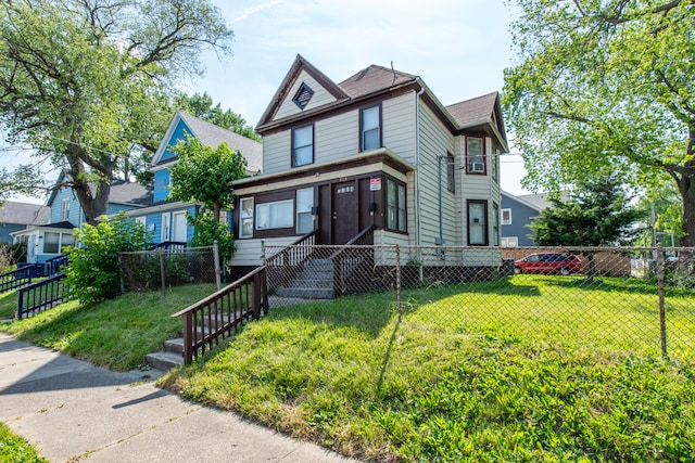 victorian-style house with a front yard