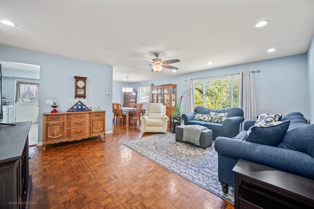 living room featuring dark parquet floors and ceiling fan