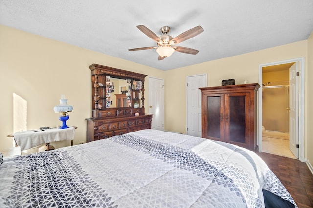 bedroom featuring ensuite bathroom, parquet floors, a textured ceiling, and ceiling fan