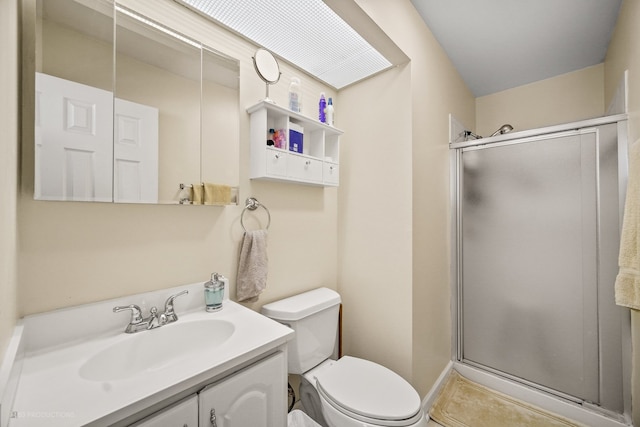 bathroom featuring tile patterned flooring, vanity, toilet, and a shower with door