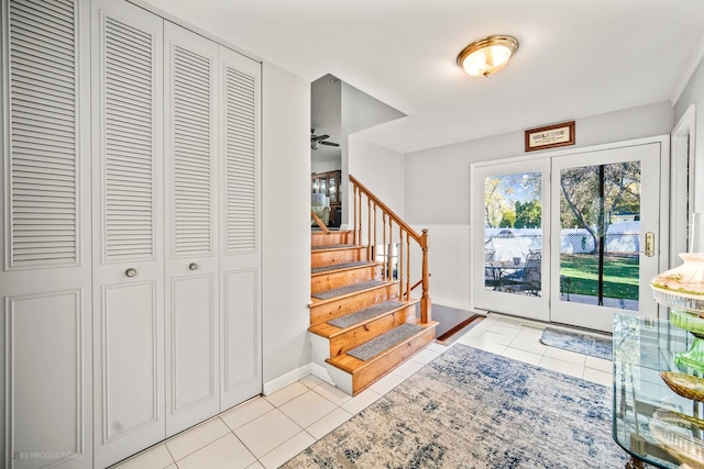 entryway with light tile patterned floors and ceiling fan