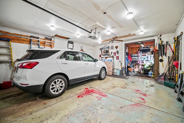 garage with a garage door opener and ceiling fan