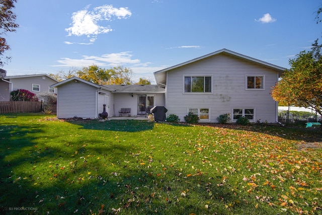 back of house with a patio and a yard