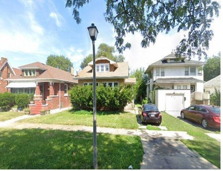 view of front of property with a front yard and a garage