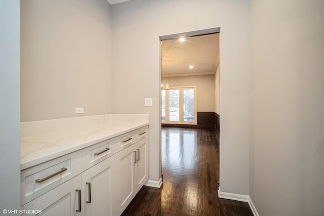 hallway with crown molding and dark hardwood / wood-style floors