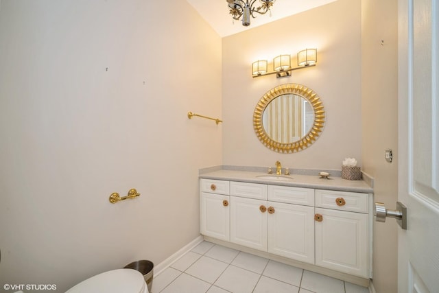 bathroom with tile patterned flooring, vanity, and toilet